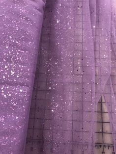 Priced per yard. Lilac glitter sequined tulle. This tulle does have some glitter shed, but not as much as some we have previously stocked. The sequins do not shed.  58/60-inches wide. Smallest length sold online: One yard. Pink Glitter Curtains, Sparkling Tulle Fabric For Party, Glitter Tulle Fabric For Evening, Purple Tulle Fabric For Party, Evening Glitter Tulle Fabric, Evening Tulle Fabric With Glitter, Sequined Glitter Tulle Fabric For Party, Party Glitter Tulle Fabric With Sequins, Party Tulle Fabric With Sequins And Glitter