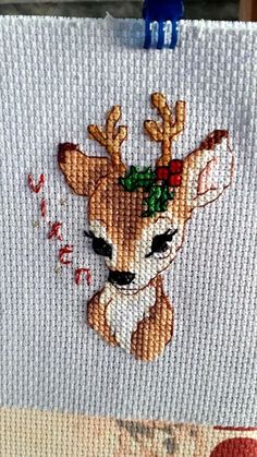 a close up of a piece of fabric with a deer on it's face