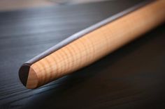 a baseball bat sitting on top of a wooden table next to a black countertop