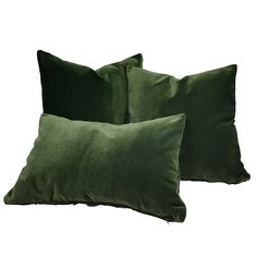 two green velvet pillows sitting next to each other