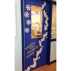 a blue door decorated with penguins and snowflakes