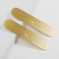 pair of brass plated door handles on white surface with space for text or image