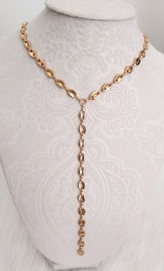 Handmade Elegant Gold Stainless Steel Mariner Y Lariat Necklace. Coffee Bean Link Y Necklace. All stainless steel. Gold color Stainless Steel Toggle Closure. Dangled chain length is ~ 5 inches long. ~ 4.5mm wide Gold Color Stainless Steel Mariner Chain. Same design available in Silver color Stainless Steel, please click on the link below: https://www.etsy.com/listing/1095347268/mariner-lariat-necklace-coffee-bean-y?click_key=899c7870e904b2a222e5fcf32b335422b4ab103c%3A1095347268&click_sum=b30aa6d Y Necklace Gold, Lariat Necklace Gold, T Shirt Necklace, Tshirt Necklace, Gold Lariat Necklace, Y Necklace, Necklace Chain Lengths, Color Coffee, Necklace Simple