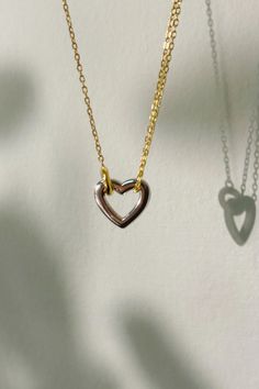 This elegant two-tone heart necklace is a harmonious blend of sophistication and sentiment. Crafted from high-quality sterling silver and accented with a gold-filled outline, this charming piece is a modern take on the classic heart pendant. Its dual-tone design makes it versatile enough to complement any outfit, whether you're aiming for a subtle, mixed-metal look or a statement piece that transcends trends. Perfect for gifting to a loved one or as a treasured addition to your own collection, this necklace is a symbol of love's enduring bond. Silver Double Heart Necklace Tarnish Resistant, Everyday Double Heart Rose Gold Necklace, Everyday Rose Gold Double Heart Necklace, Silver Tarnish-resistant Double Heart Necklace, Sterling Silver Open Heart Necklace, Tarnish Resistant, Sterling Silver Heart Necklace Tarnish Resistant, Everyday Double Heart Tarnish Resistant Necklace, Tarnish Resistant Sterling Silver Open Heart Necklace, Tarnish Resistant Open Heart Sterling Silver Necklace