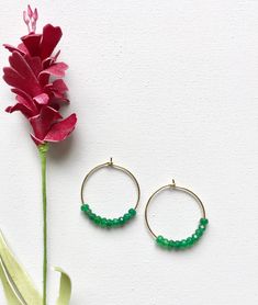 Emerald Hoop Earrings. Ten faceted emeralds adorn each hoop for a total of 20 emeralds in these beautiful earrings! These are perfect with jeans and a t-shirt or to wear with your best outfit! The hoops measure 1-1/4 inches in length and width or just over 3 cm. These earrings are available in either gold plated or rhodium plated finish. Emerald is the May birthstone. Your emerald hoop earrings will arrive gift boxed. If this is a gift, I would be glad to include a card with your personal messag Elegant Hoop Earrings With Faceted Beads, May Birthstone Round Hoop Earrings, May Birthstone Round Hoop Earrings For Pierced Ears, Faceted Hoop Earrings As Gift, Small Hoop Earrings With Faceted Beads For Gift, Small Hoop Jewelry With Faceted Beads For Gifts, Hoop Jewelry With Faceted Beads For Gifts, Faceted Beads Dangle Hoop Earrings For Gifts, Gift Hoop Earrings With Faceted Beads