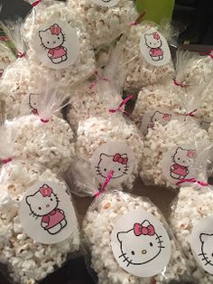 hello kitty popcorn balls are wrapped in cellophane and tied with pink ribbon for decoration