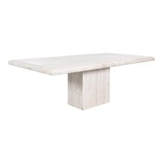 a white marble dining table with a square base and four leaves on the top, viewed from the front