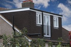 an image of a house that is very close to the camera with clouds in the background