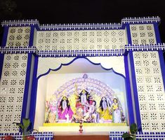 an elaborately decorated stage with statues on it