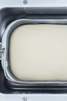 an old fashioned oven with white bread in the bottom and silver trim on it's side