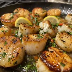 cooked scallops with lemon and parsley in a frying pan