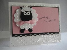 a pink and white card with a black sheep on it's side, in front of a white background