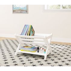 a white bench sitting on top of a rug next to a book shelf filled with books