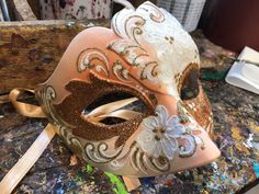 "Original Venetian Colombina mask, hand painted embellished with Glitter, decoration with stucco and acrylic colors. -Material/Resin Made in Italy hypoallergenic and non-toxic. -Dimensions/16x8 Unisex -History of the mask/ \"Colombina\" is an ancient mask dating back to the 15th century. She represents a cunning and lying servant at the court of often very rich men such as the greedy and rich Venetian merchant \"Pantalone\" of Carlo Goldoni's commedia dell'arte. -Shipping/worldwide We ask you to Hand Painted Masks And Prosthetics For Carnival, Hand Painted Masks For Masquerade Carnival, Hand Painted Masks For Carnival Masquerade, Artistic Masquerade Mask For Carnival Festivals, Traditional Masquerade Mask For Carnival Festivals, Traditional Masquerade Mask For Carnival, Traditional White Masquerade Mask For Carnival, Traditional Carnival Eye Mask Masquerade, Traditional Carnival Eye Masquerade Mask