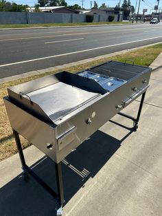 a grill sitting on the side of a road