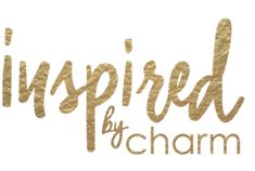 the logo for inspired by charm is shown in gold foil on a white background with black lettering