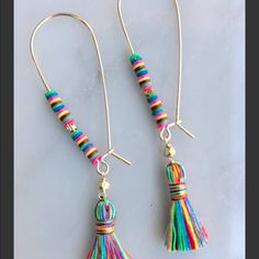 two pairs of colorful tasselled earrings with gold hooks