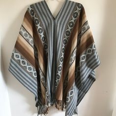 "This is a traditional heavy weight Andean poncho made by one of our most talented weavers. The natural fiber yarn is hand-dyed and woven into beautiful patterns and color arrangements. Perfect to keep you warm around ceremonial fires! There is yarn fringe at the bottom.  One size fits most adults. Unisex. Dimensions: 66\" x 44\" Peruvian woven textiles are incomparable in their quality and beauty. Add this to your collection today! We are a non-profit organization and proceeds from all sales go Woven Poncho Pattern, Bohemian Woven Poncho For Fall, Fall Bohemian Woven Poncho, Traditional Handwoven Poncho For Fall, Bohemian Handwoven One-size Cape, Bohemian One-size Handwoven Cape, Artisan Alpaca Poncho For Fall, Handwoven Folk Shawl One Size, Folk Style Handwoven Shawl