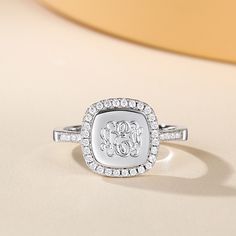 Monogram rings are the perfect option for fashionistas everywhere with a taste for elegance. This monogram ring features sparkling stones around the engravable ring face as well as halfway around the single straight band. Available in silver, gold, and rose gold! Select your preferred metal color, ring size, and initials from the drop-down boxes.Material: 925 SilverPlating Color: Silver Elegant Personalized Diamond Rings, Elegant Personalized Round Cut Rings, Classic White Gold Initial Ring With Cubic Zirconia, Classic White Gold Initial Diamond Ring, Classic White Gold Diamond Initial Ring, Personalized White Gold Diamond Ring, Silver Initial Ring With Diamond Accents, Formal Silver Initial Ring With Diamond Accents, Silver Engraved Monogram Ring