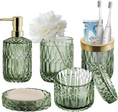 green glass bathroom accessories including toothbrushes and soap dispenser