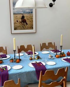 a dining room table is set with plates and place settings for the dinner guests to eat