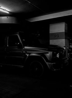 a black and white photo of a truck in a parking garage