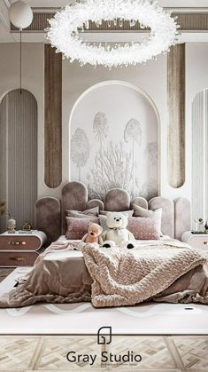 a teddy bear sitting on top of a bed in a room with chandelier