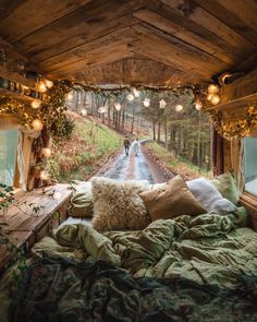 a person walking down the road from a bed in a room with lights on it