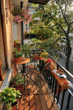 an outdoor balcony with potted plants and tables