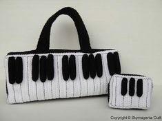 a black and white handbag with two matching purses