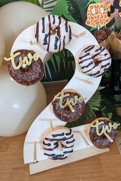 two decorated donuts sitting on top of a white plate