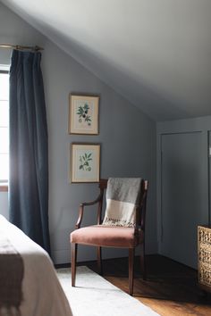 a chair sitting next to a window in a bedroom