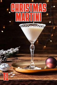 a christmas martini in a glass on top of a wooden table