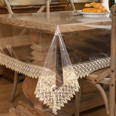 an image of a table setting with doily on the table and food in the background