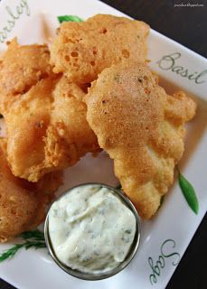 some fried food on a white plate with dip