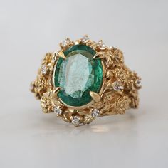 Read about our payment plans before proceeding. Our "Tulip Majesty Emerald Bloom Ring." A mesmerizing oval emerald, reminiscent of a lush oasis, is embraced by delicate tulip petals, accented by sparkling diamonds. Experience the essence of spring's romance captured in this timeless treasure. Perfect for those who seek nature's elegance and enduring beauty. Crafted by skilled hands, this ring is available in your choice of 14K and 18K yellow gold, rose gold, and white gold. All emeralds are natural so it can differ from the image. All orders come in our Tippy Taste ring box. This ring is handmade and designed in NYC. 14K or 18K solid gold Natural 10*8mm oval emerald. Approx. 2.5ct Natural diamonds. SI clarity, GH color, 0.08ct total carat weight ** Tippy Taste Heirloom Collection is made t Oval Emerald Ring With Rose Cut Diamonds, Nature-inspired Green Oval Emerald Ring, Exquisite Oval Emerald Ring With Rose Cut Diamonds, Nature-inspired Oval Emerald Ring, Exquisite Oval Emerald Ring In Yellow Gold, Tulip Ring, Tulip Petals, Fall Rings, Timeless Treasures