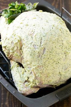 a large piece of meat sitting on top of a pan filled with broccoli