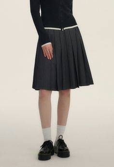 Step into chic sophistication with our Pinstripe Pleated Short-Midi Skirt, a versatile piece tailored to add a touch of moody elegance to your wardrobe.

Crafted with a blend of 70% polyester fiber, 28% viscose, and 2% spandex, this skirt ensures comfort without compromising on style. The classic pinstripe pattern exudes professionalism, while the pleated design adds a playful twist. It's finished with a discreet embroidered logo that subtly elevates the overall aesthetic.

Perfect for transitioning from day to night, pair this skirt with a crisp button-down for business hours or a casual tee for an effortless weekend look. Its A-line cut flatters the natural waist and the length hits just at the knee, making it suitable for various occasions and seasons.

Product specifications:
Material: Skirt Korean, Pinstripe Pattern, A Line Cut, Pleated Shorts, Casual Tee, Korean Fashion, Midi Skirt, Overalls, Twist