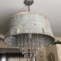 an old bucket chandelier hanging from the ceiling