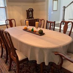 a dining room table with candles on it