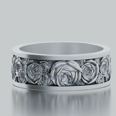 a white gold wedding band with roses on the inside and inlayed to it