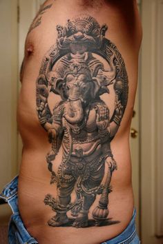 an elephant tattoo on the side of a man's stomach is shown in this image