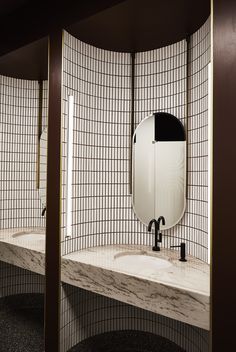 a bathroom with two sinks and mirrors in it