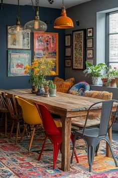 a dining room table surrounded by chairs and potted plants