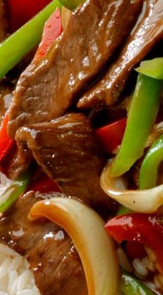 beef and vegetables with rice on a plate