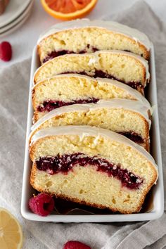 slices of lemon raspberry pound cake with icing on a white platter