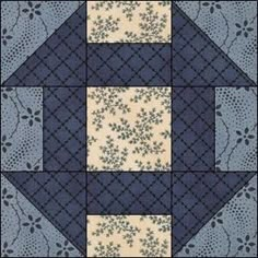 a blue and white patchwork quilt with an intricate design on the center, in squares