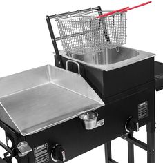 an electric grill with a basket on the top and side burners attached to it