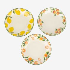 three plates with oranges and leaves painted on them