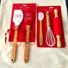 two wooden utensils and one whisk are sitting on a white cloth